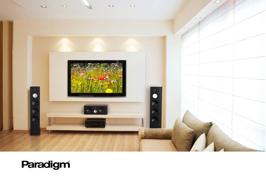 a living room with floor-standing speakers next to a wall-mounted TV