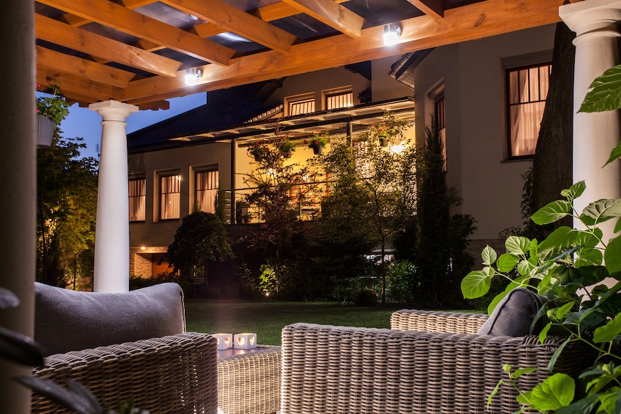 An outdoor patio space lit with landscape lighting design.