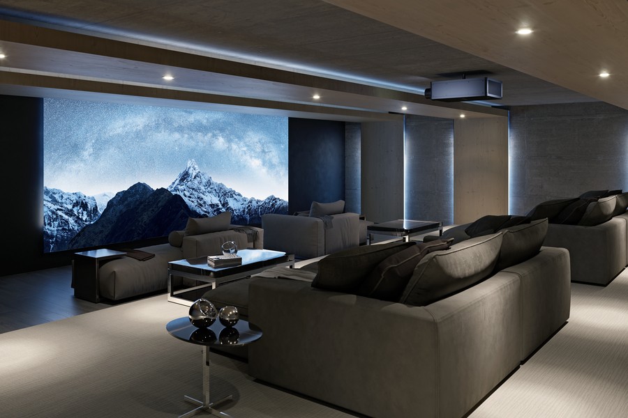 A home theater with chaise lounges, a Sony projector, and a large movie screen. 