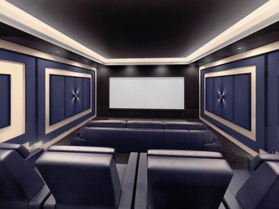 A home theater design and setup with comfy seating, acoustic paneling, and a large screen display.
