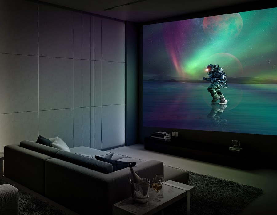 A modern home theater with a large projector screen displaying a vivid image of an astronaut walking on a reflective surface under a colorful aurora sky. The room features comfortable seating, a sleek design, and ambient lighting.