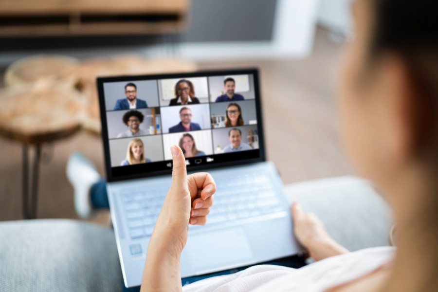 Woman on a laptop in a remote team video conference.